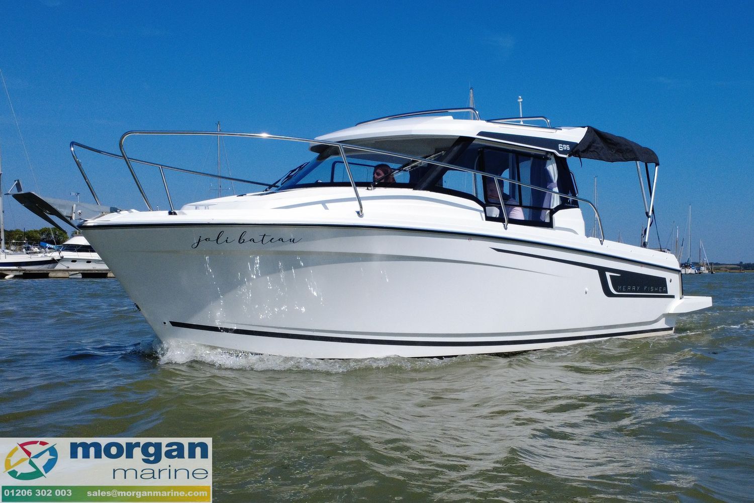 Jeanneau Merry Fisher 695 Series 2 2021 Jeanneau Merry Fisher 695 Series 2 boat cruising on water under clear blue sky.