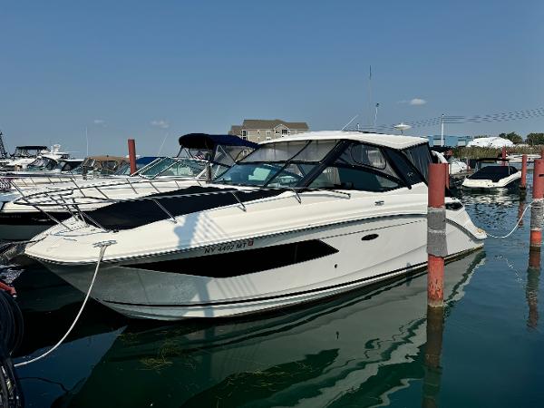 Sea Ray Sundancer 320 2019 Sea Ray Sundancer 320 docked in a marina under clear skies.