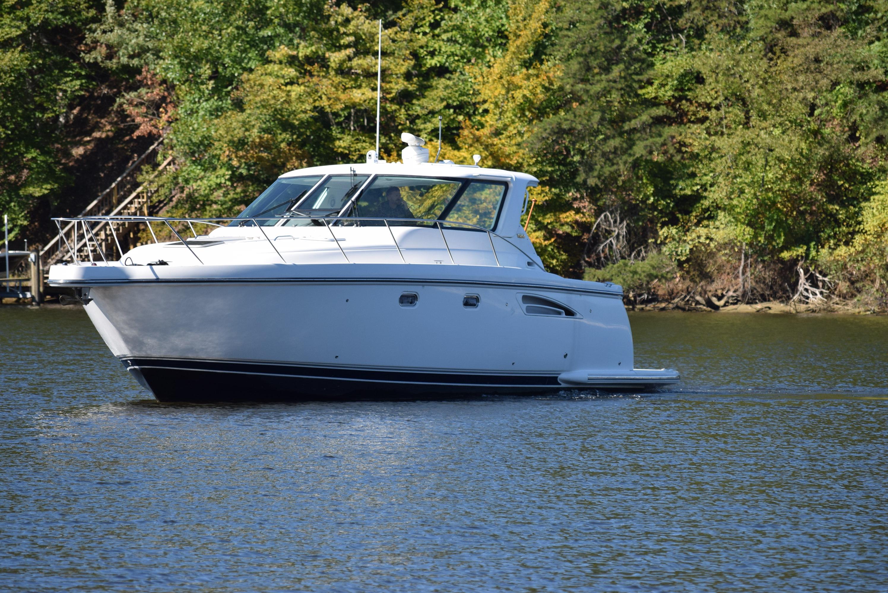 Tiara Yachts Sovran 3600 2004 Tiara Yachts Sovran 3600 cruising on a serene lake with lush green backdrop.