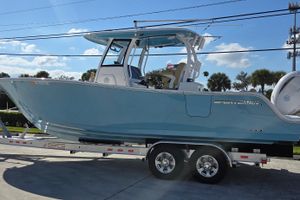 Sportsman Open 282TE Center Console 2022 Sportsman Open 282TE Center Console boat on trailer, blue hull, sunny day.