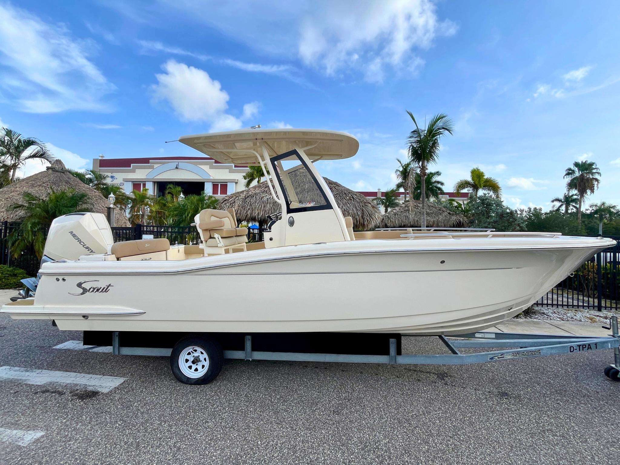 Scout 240 XSF 2025 Scout 240 XSF boat on trailer, parked outdoors under blue sky.