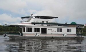 Stardust Cruisers 6816 Houseboat on water, Stardust Cruisers 6816, 2000 model, with canopy and windows.