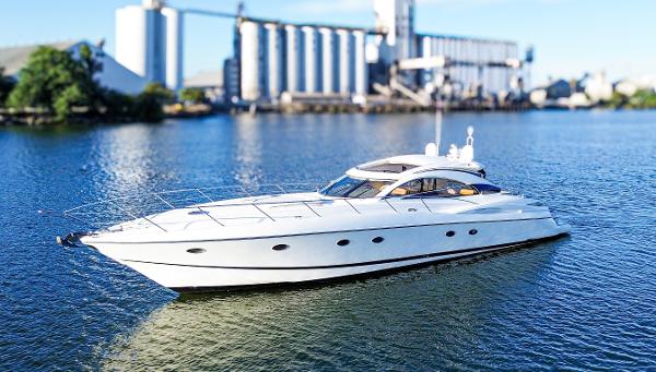 Sunseeker Predator 61 2002 Sunseeker Predator 61 yacht on calm water with industrial backdrop.