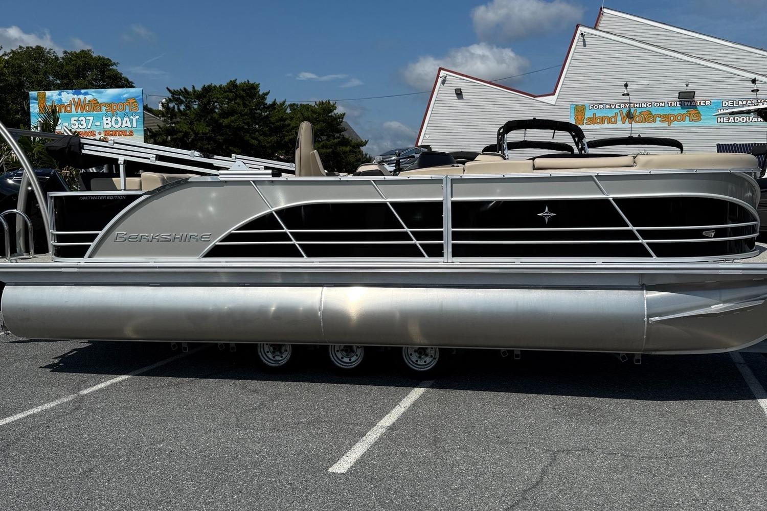 Berkshire 23CL STS 3.0 2025 Berkshire 23CL STS 3.0 pontoon boat parked outdoors on a sunny day.