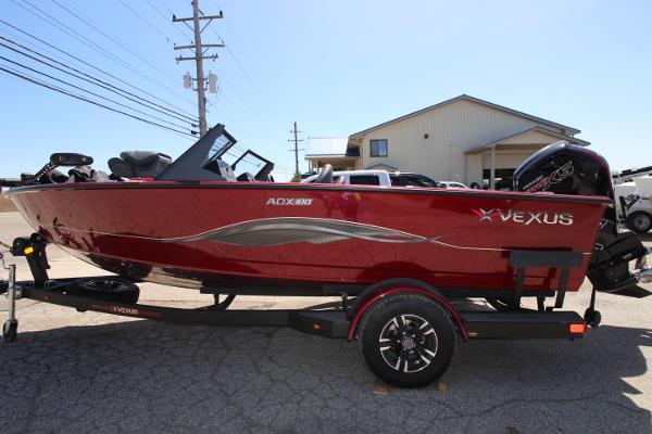 Vexus ADX180LS 2025 Vexus ADX180LS boat in red, parked on a trailer outdoors.