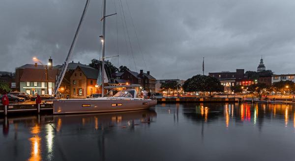 Beneteau Oceanis Yacht 54 2025 Beneteau Oceanis Yacht 54 docked at night, reflecting city lights on water.