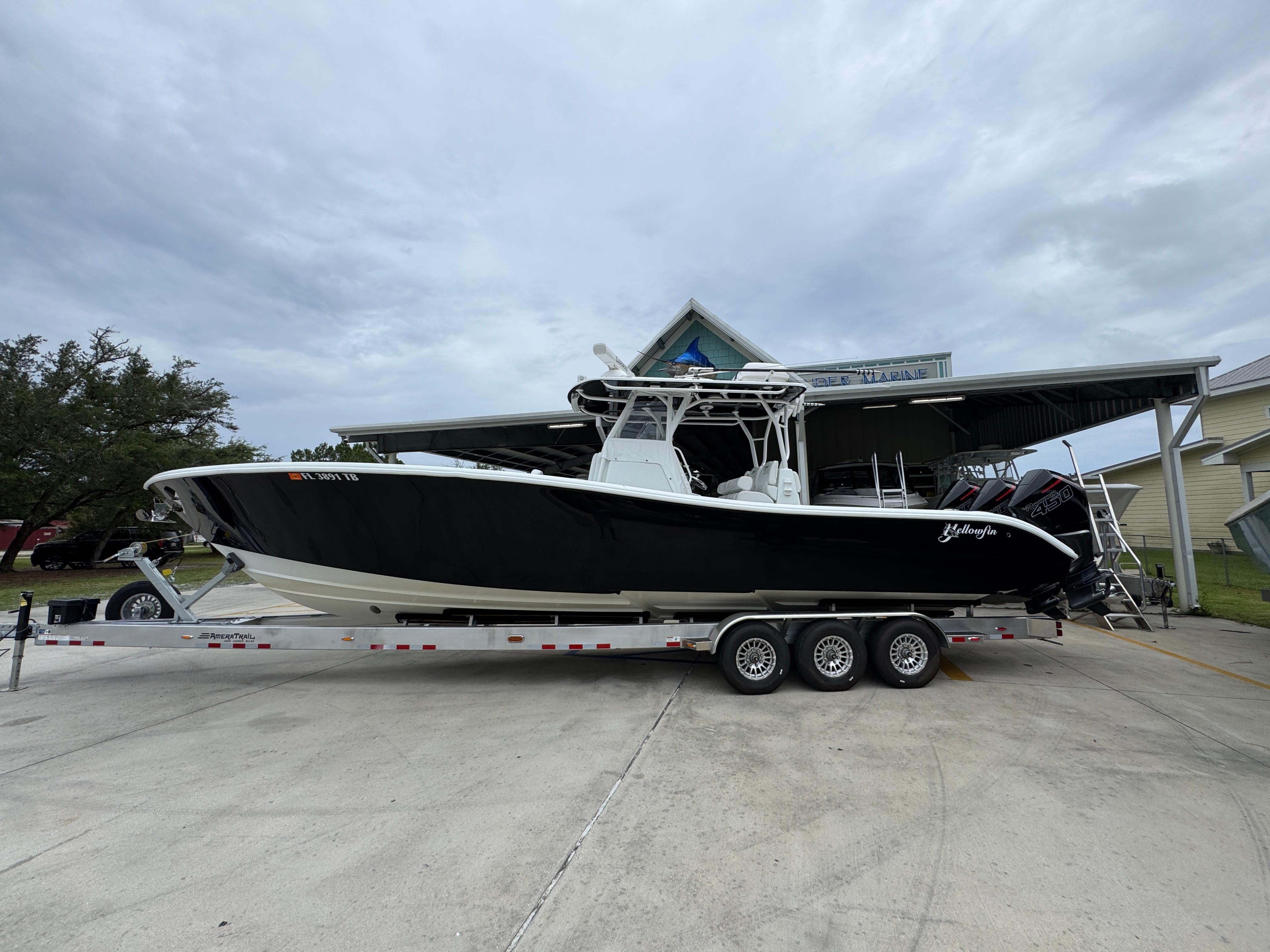 Yellowfin 36 Offshore 2021 Yellowfin 36 Offshore boat on trailer, parked outdoors under cloudy sky.