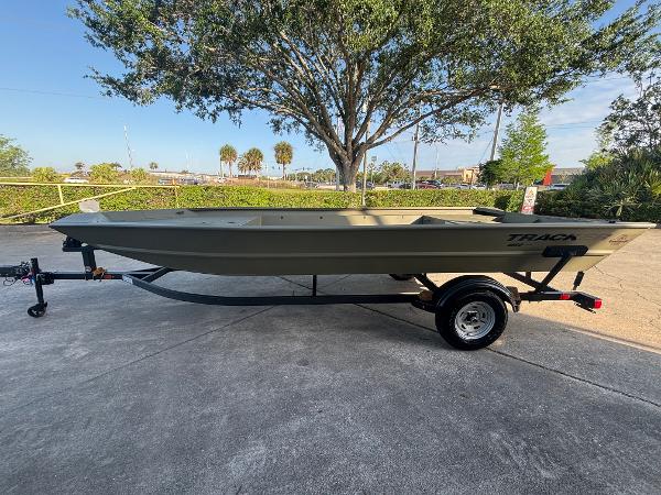 Tracker GRIZZLY 1860 Utility 2025 Tracker GRIZZLY 1860 Utility boat on trailer, parked outdoors.
