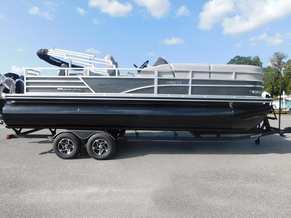 Ranger Reata 223FC 2024 Ranger Reata 223FC pontoon boat on a trailer under a blue sky.