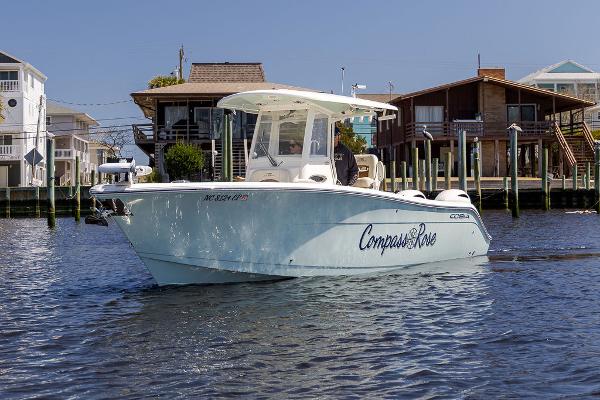 Cobia 280 Center Console 2020 Cobia 280 Center Console boat on water near waterfront homes.