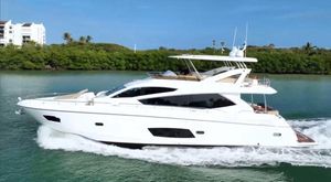Sunseeker Manhattan 73 2013 Sunseeker Manhattan 73 yacht cruising on a serene waterway.