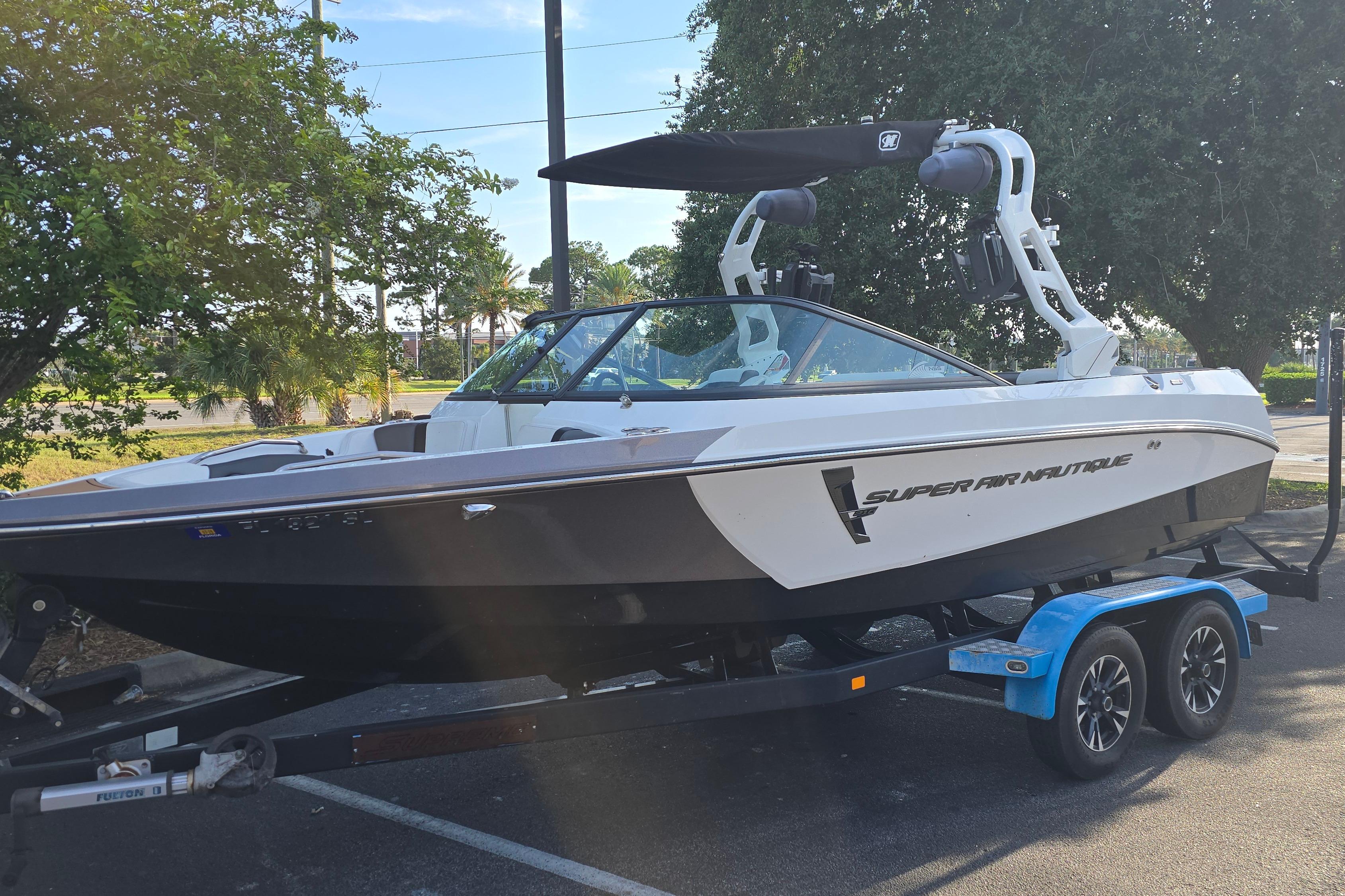 Nautique Super Air Nautique 210 2019 Nautique Super Air Nautique 210 boat on trailer, parked outdoors.