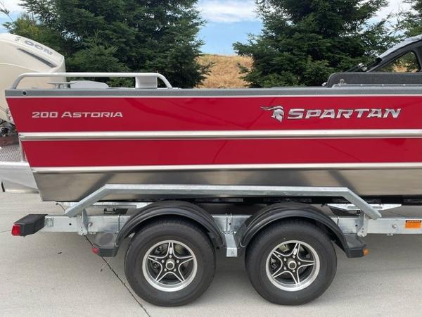 Spartan 200 Astoria 2025 Spartan 200 Astoria boat on trailer, red and silver design.