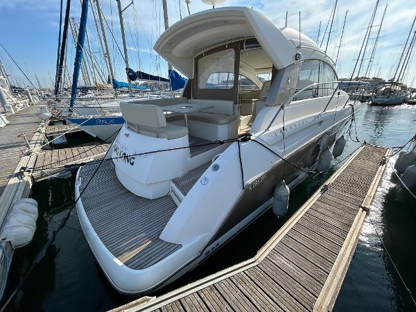 Jeanneau Prestige 38 S. 2008 Jeanneau Prestige 38 S yacht docked at marina, showcasing sleek design and spacious deck.