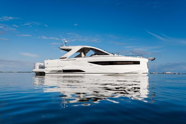 Jeanneau DB/37 OB 2025 Jeanneau DB/37 OB yacht on calm water under clear blue sky.