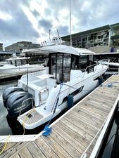 Jeanneau NC 895 2019 Jeanneau NC 895 boat docked with Yamaha engines, cloudy sky background.
