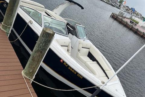Cobalt R7 2015 Cobalt R7 boat docked at a marina, featuring sleek design and spacious seating.