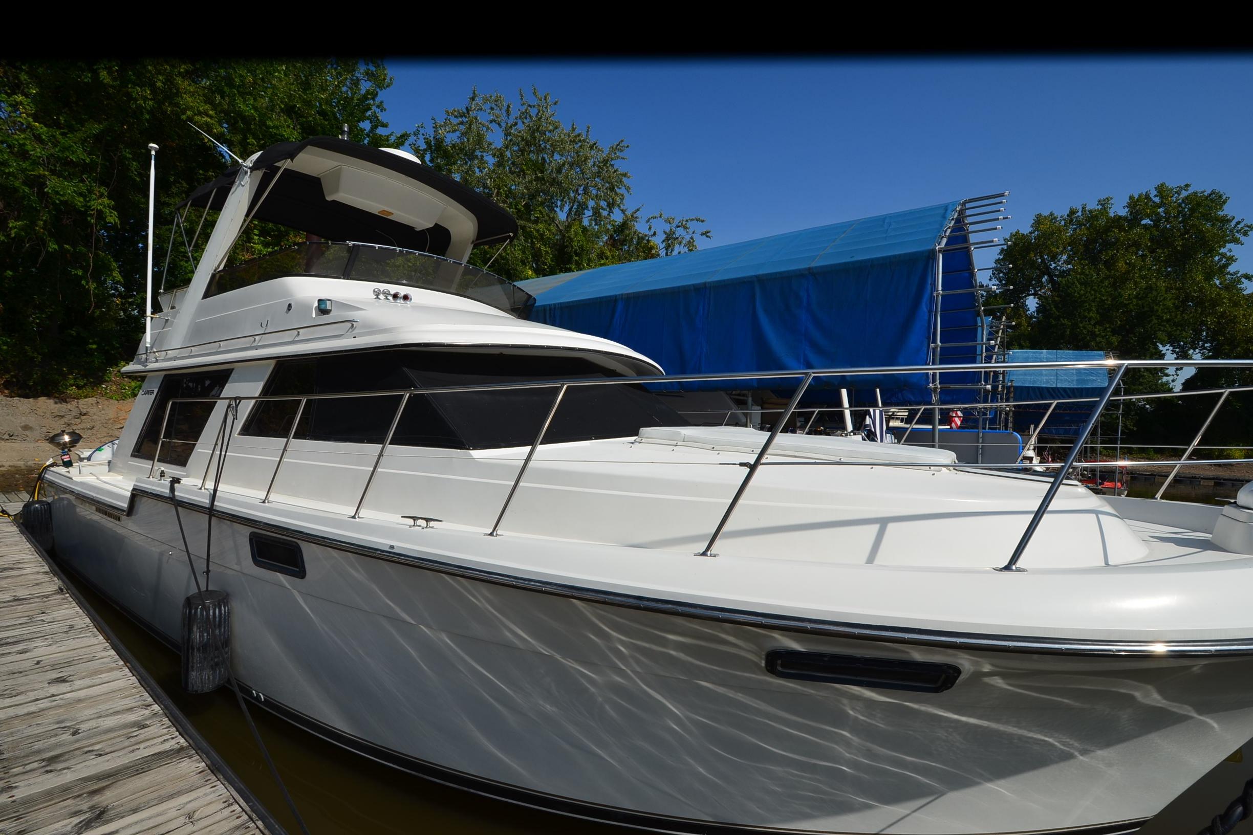 Carver 4227 Cockpit Motor Yacht 1986 Carver Cockpit 4227 MY yacht docked, featuring sleek design and spacious deck.