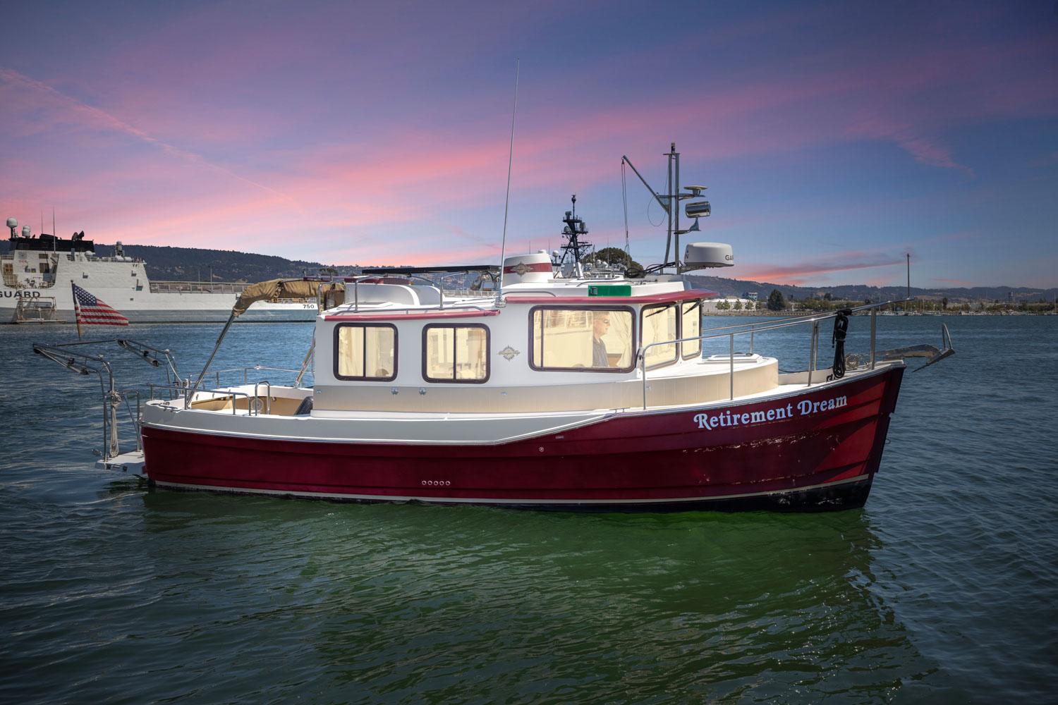 Ranger Tugs R-27 2014 Ranger Tugs R-27 boat named "Retirement Dream" on water at sunset.