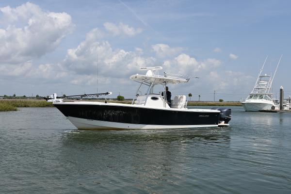 Regulator 28 Forward Seating 2012 Regulator 28 Forward Seating boat on calm water under a cloudy sky.