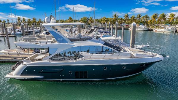 Azimut 50 Luxury 2016 Azimut 50 yacht docked in marina, surrounded by palm trees and clear blue sky.