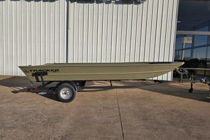 Tracker Grizzly 1860 Utility 2025 Tracker Grizzly 1860 Utility boat on trailer, parked outside a building.