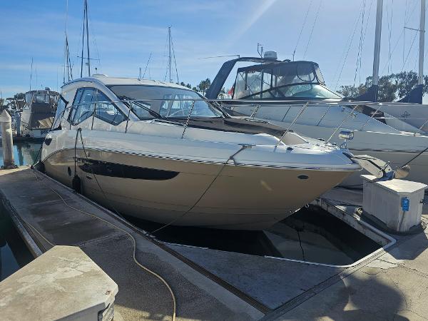 Sea Ray Sundancer 350 Coupe 2017 Sea Ray Sundancer 350 Coupe docked at marina under clear blue sky.