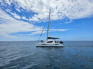 Leopard 48 Sailing catamaran Leopard 48 on open sea under a partly cloudy sky.