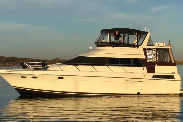 Silverton 46 Motor Yacht 1991 Silverton 46 Motor Yacht cruising on calm water at sunset.