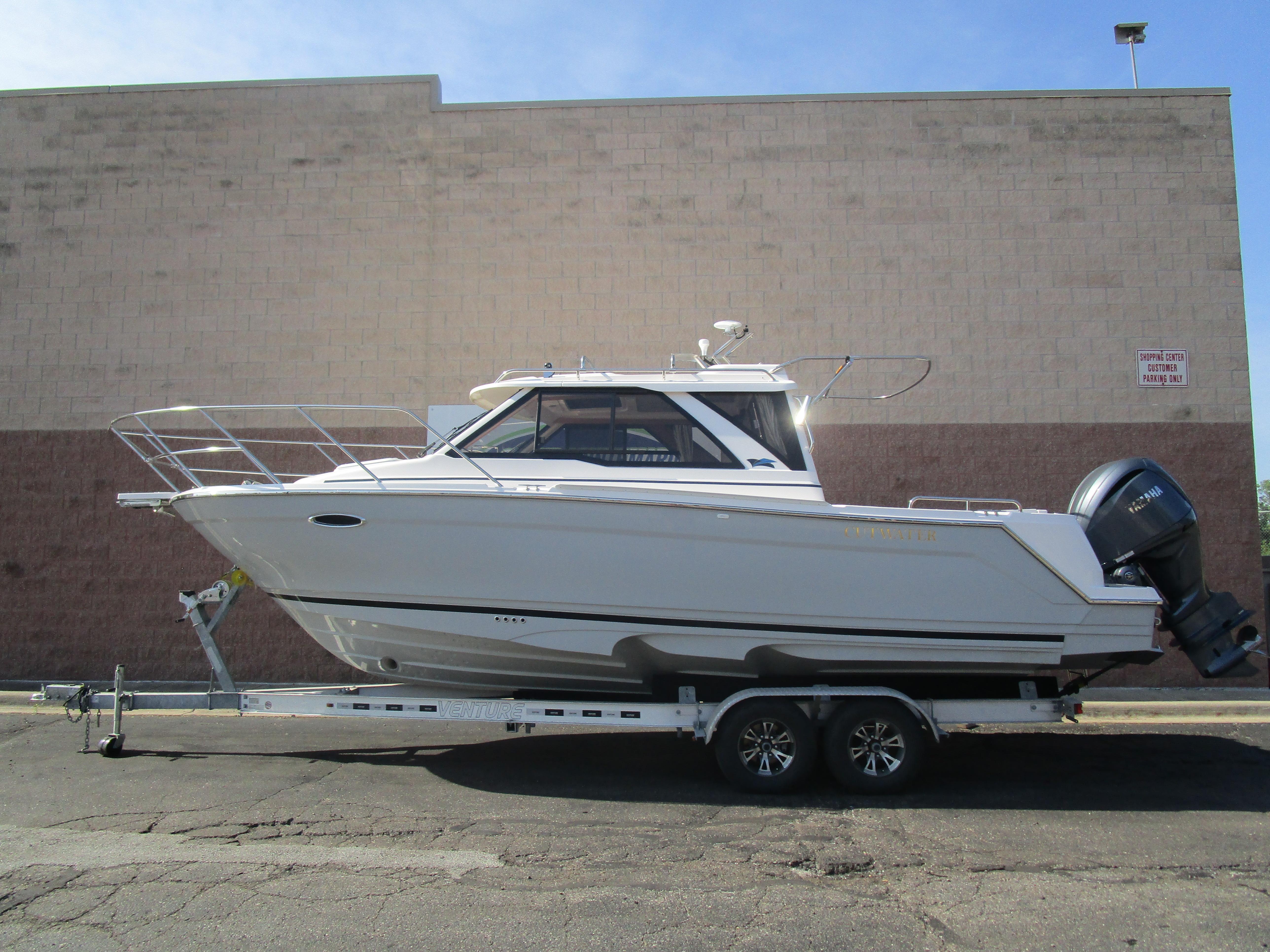 Cutwater C-248 Coupe 2025 Cutwater C-248 Coupe boat on trailer, parked outdoors.