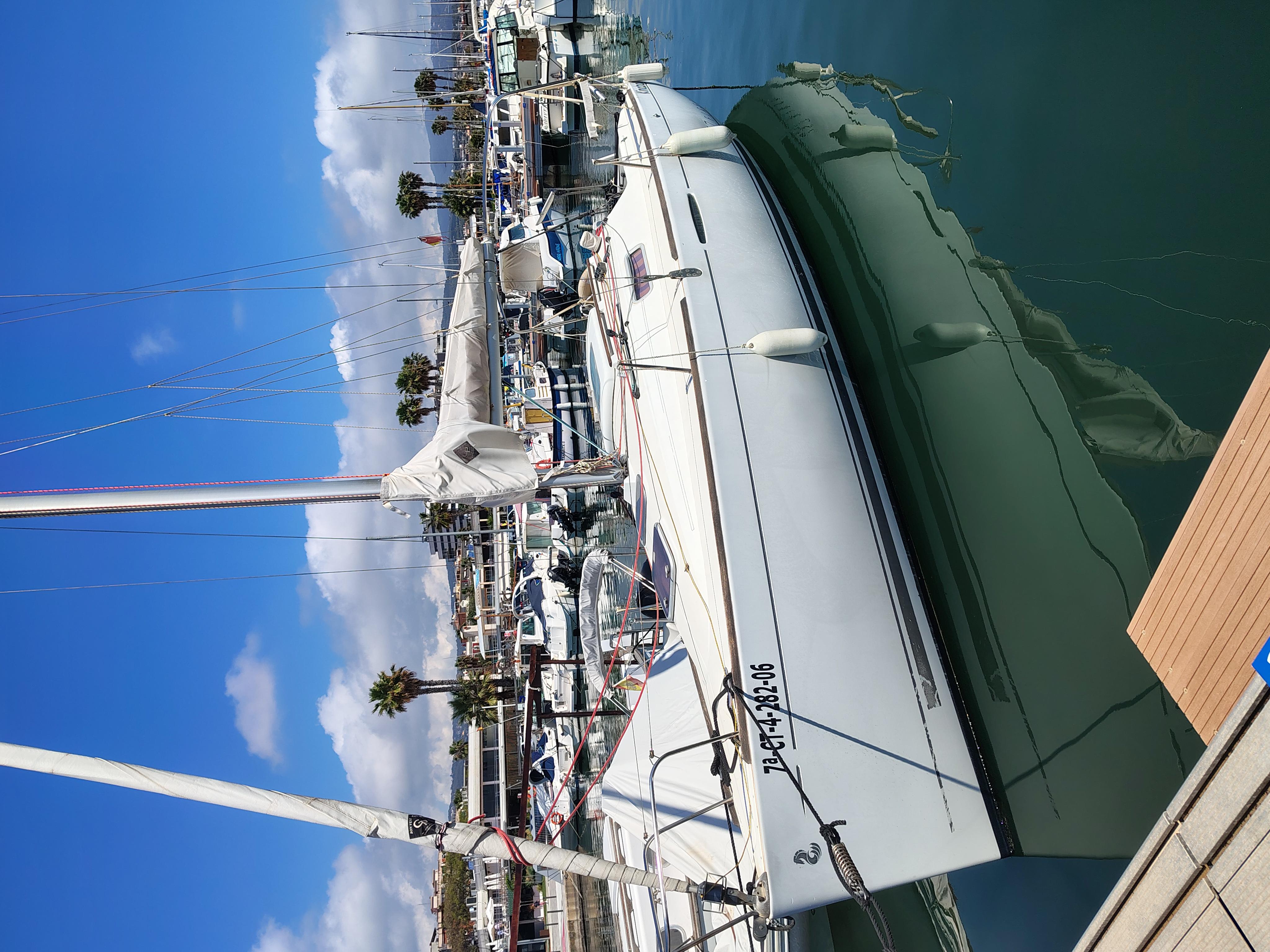 Beneteau First 25.7 S Sailboat Beneteau First 25.7 S, 2006 model, docked in a marina under clear blue skies.