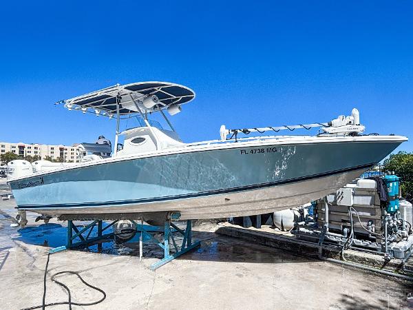 Island Runner 26 Center Console 2003 Island Runner 26 Center Console boat on a stand, clear blue sky background.