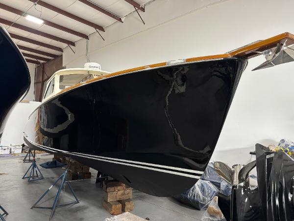 Hinckley Picnic Boat 36 2002 Hinckley Picnic Boat 36 in storage, showcasing sleek black hull and classic design.