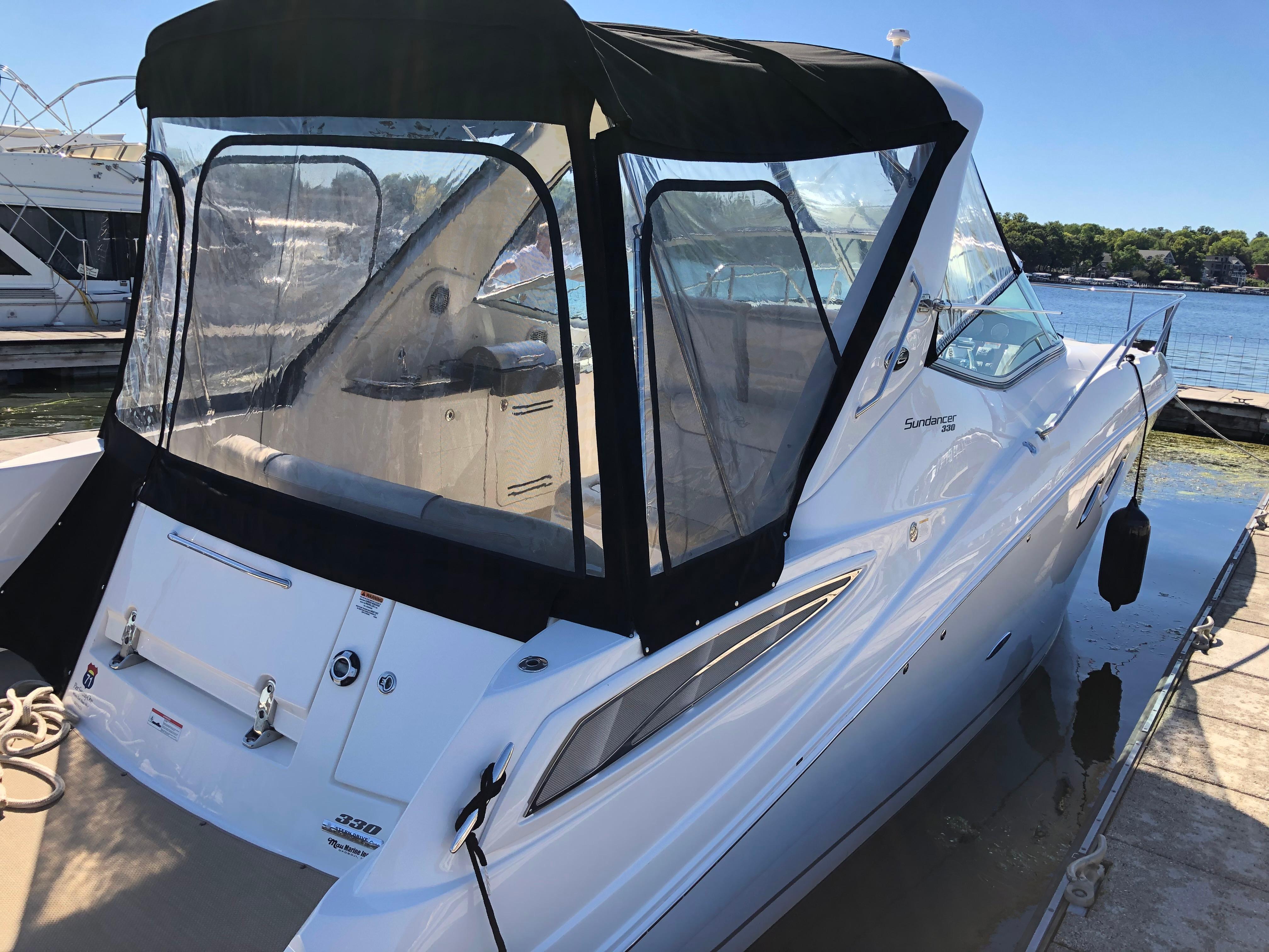 Sea Ray 330 Sundancer 2012 Sea Ray 330 Sundancer boat docked with black canopy and clear windows.