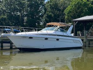 Donzi 3250 LXC 1997 Donzi 3250 LXC boat docked on a calm river.