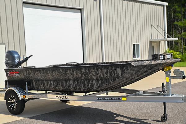 Reaper Boats TIMBER REAPER 756 2024 Reaper Boats TIMBER REAPER 756 on trailer, parked outside a building.
