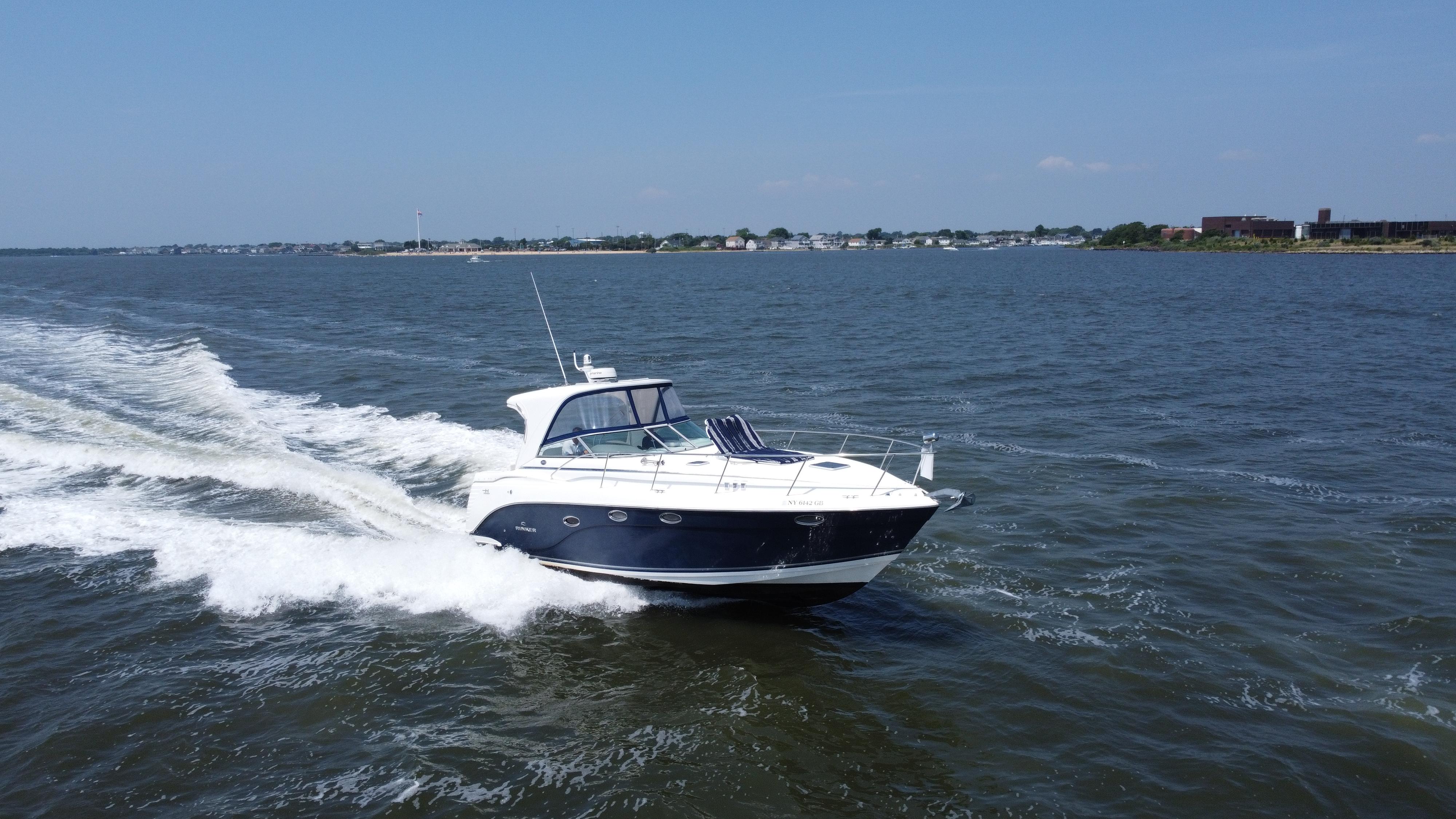 Rinker 360 Express Cruiser 2006 Rinker 360 Express Cruiser speeding on open water under clear skies.