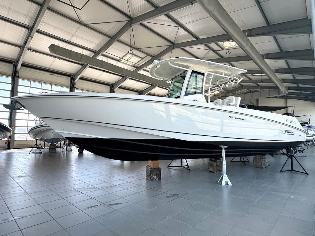 Boston Whaler 320 Outrage 2012 Boston Whaler 320 Outrage boat displayed in a spacious indoor showroom.