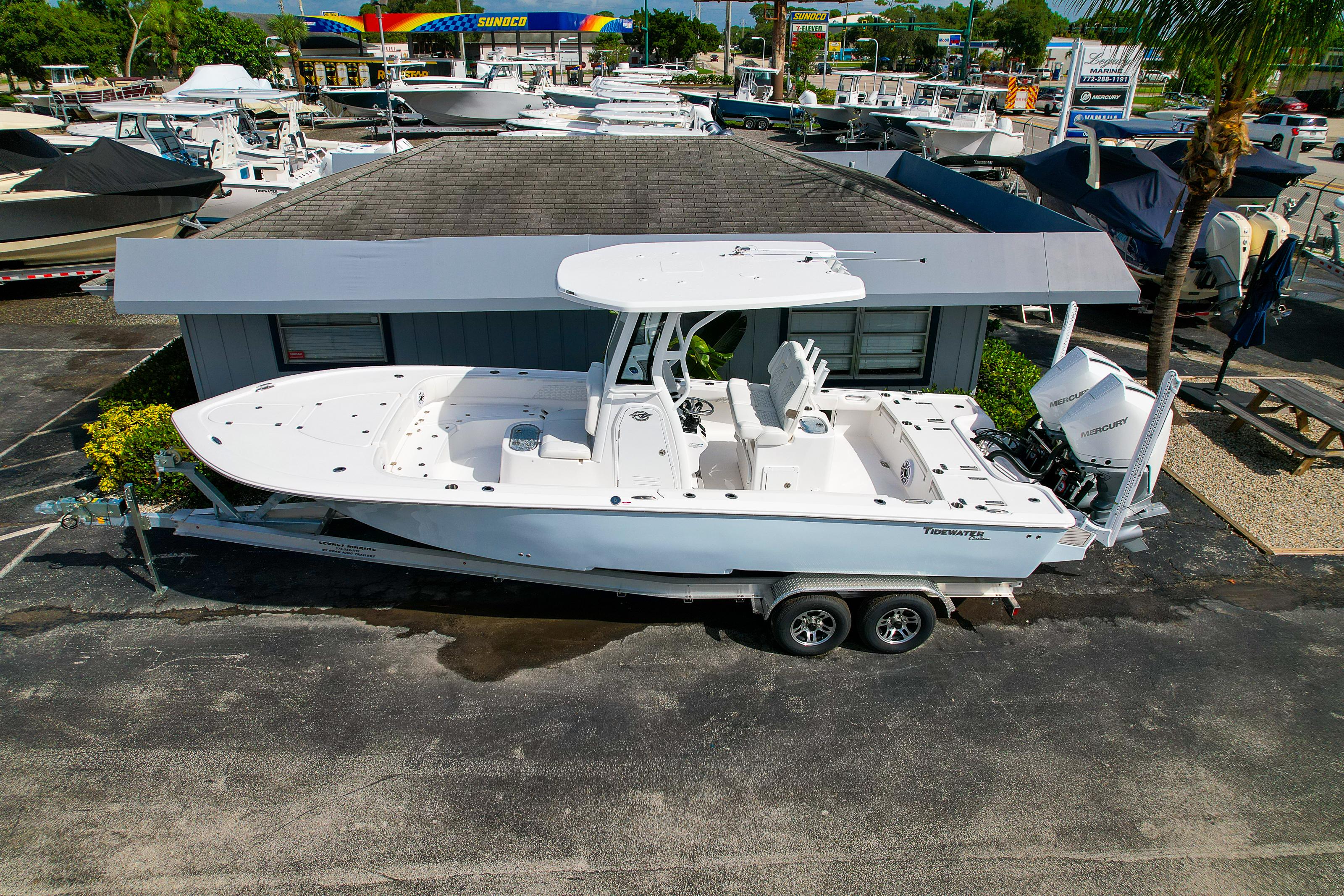 Tidewater 2700 Carolina Bay 2026 Tidewater 2700 Carolina Bay boat on trailer at dealership, surrounded by other boats.