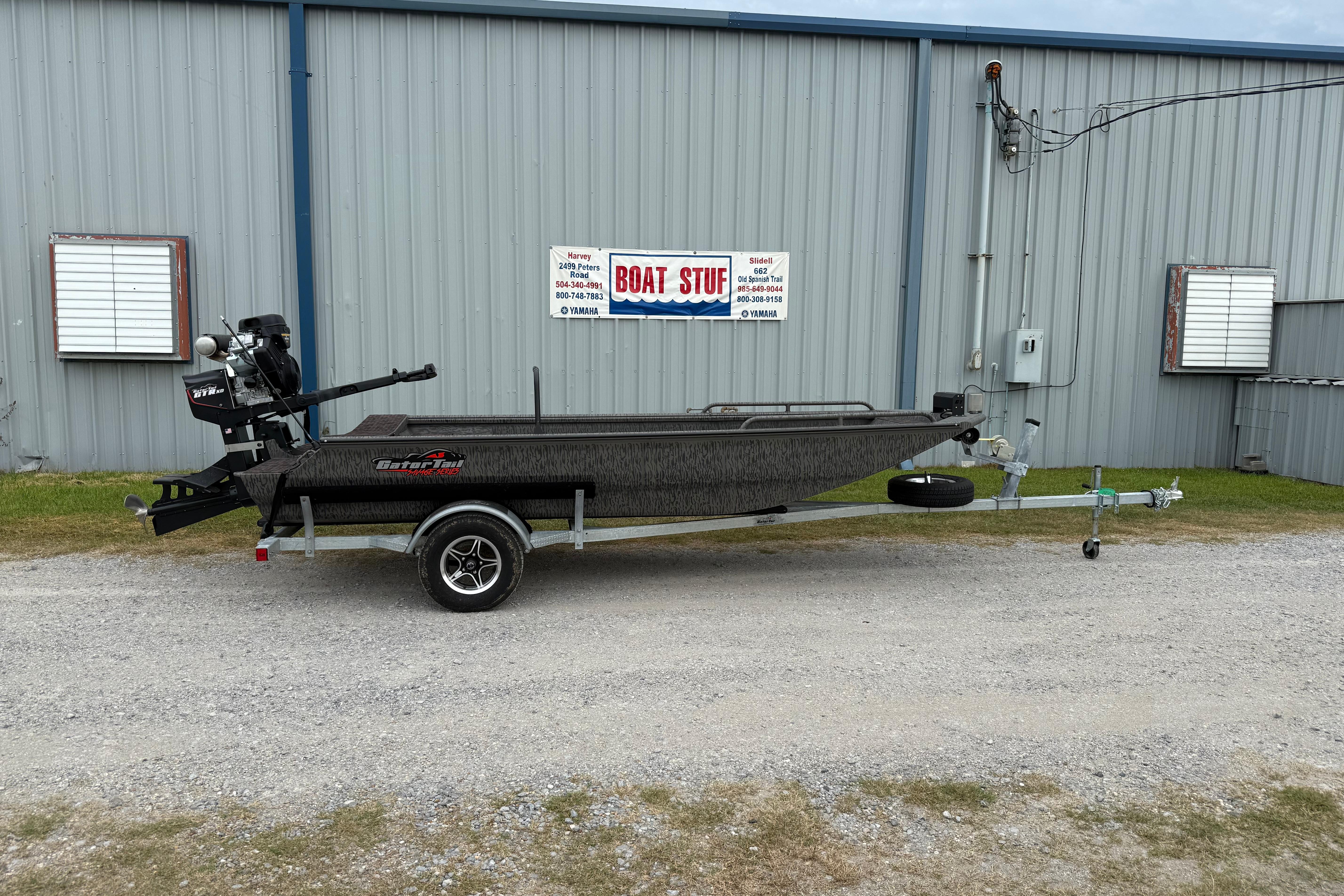 Gator-tail 1750 MID DECK SAVAGE 2026 Gator Tail 1750 MID DECK SAVAGE boat on trailer outside metal building.