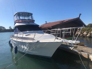 Mediterranean 38 Sport Fisher 1990 Mediterranean 38 Sport Fisher boat docked by a wooden pier under clear blue skies.