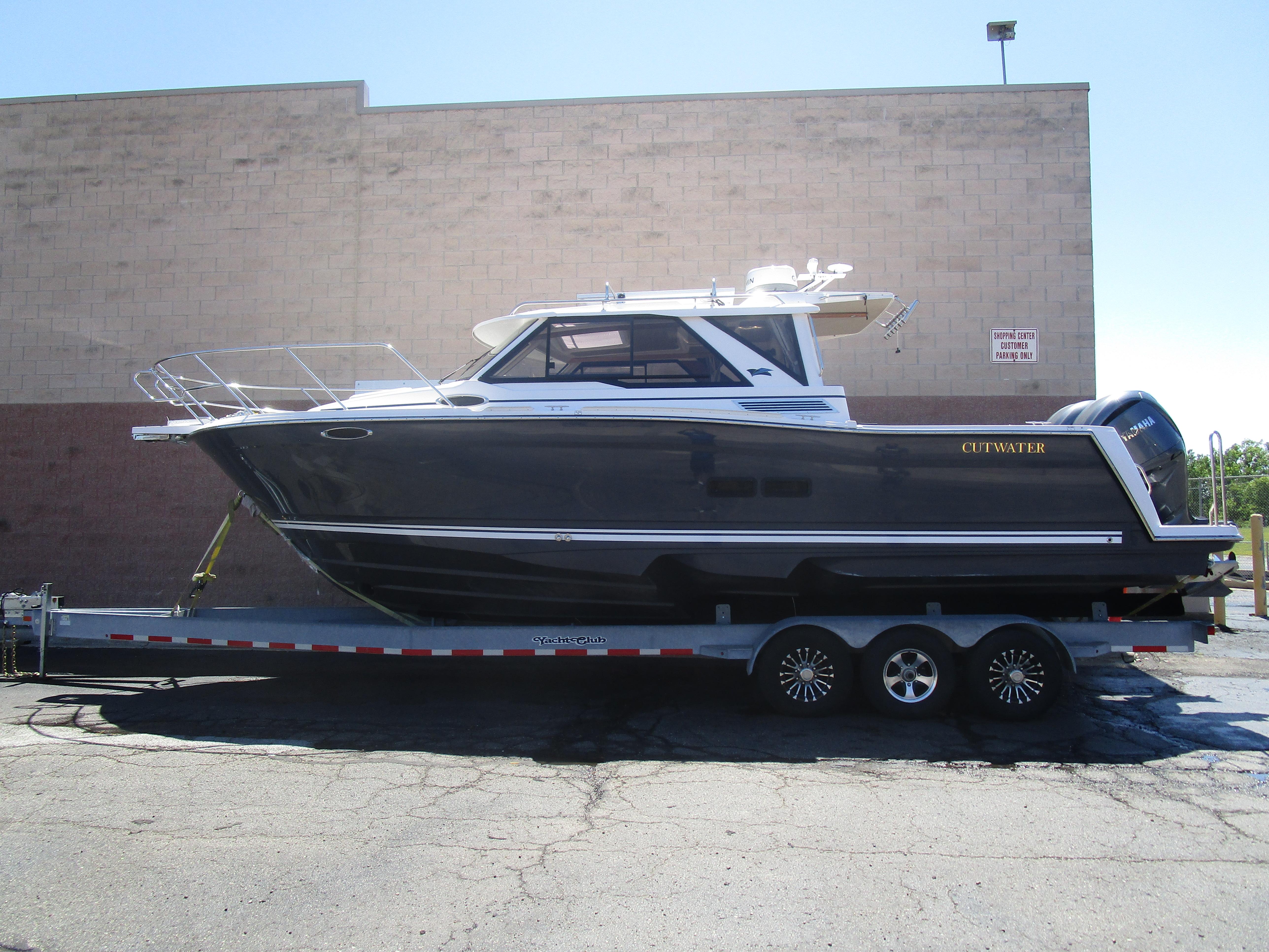 Cutwater C-288 Coupe 2025 Cutwater C-288 Coupe boat on trailer, parked outdoors.