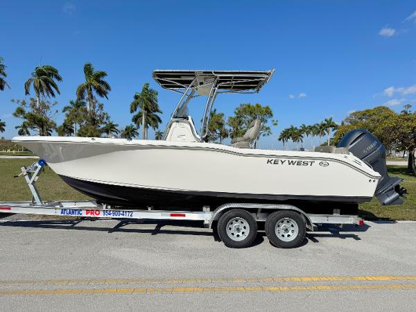 Key West 239 FS 2022 Key West 239 FS boat on trailer, palm trees in background.