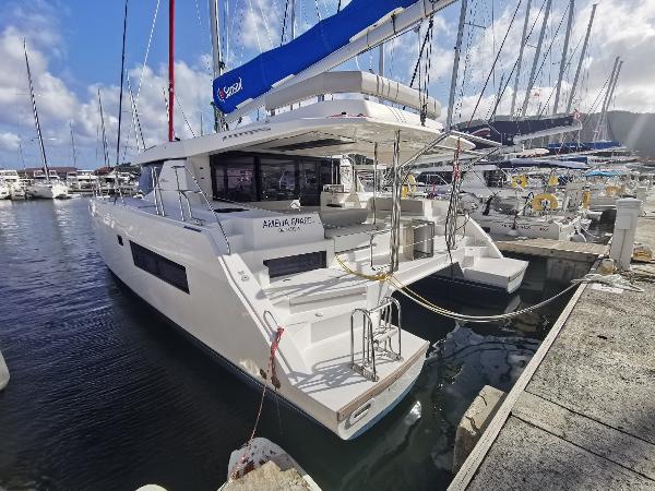 Leopard 45 2022 Leopard 45 catamaran docked at marina, featuring sleek design and spacious deck.