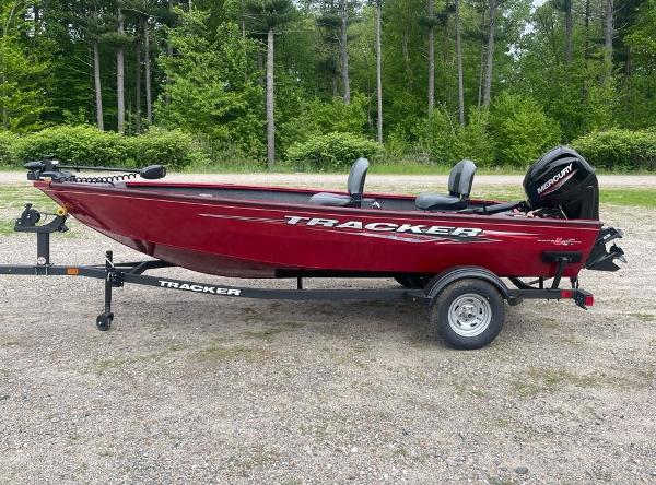 Tracker Super Guide V-16 T 2025 Tracker Super Guide V-16 T boat on trailer, red color, parked outdoors.