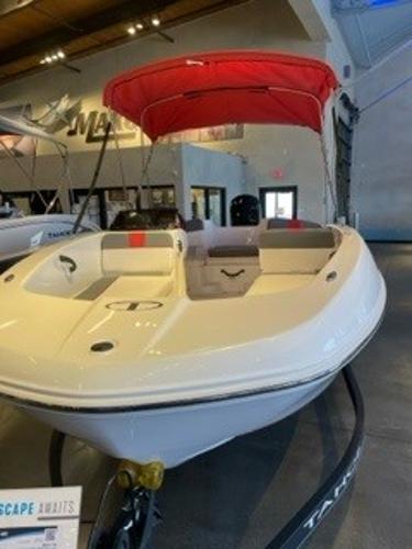 Tahoe T18 2024 Tahoe T18 boat with red canopy on display in showroom.