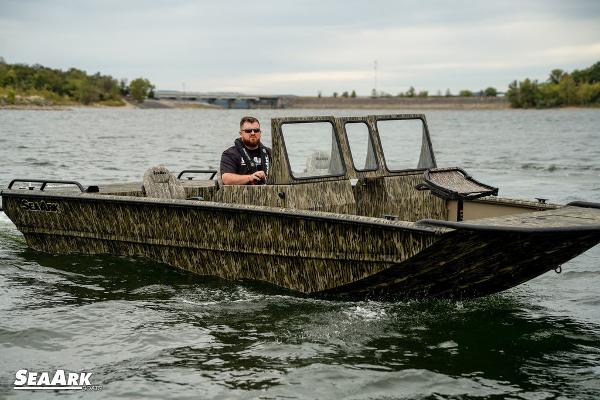 SeaArk Predator 2025 SeaArk Predator boat cruising on a lake with a camo design.