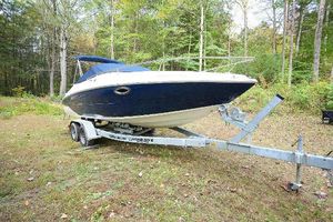 Stingray 225 CR 2016 Stingray 225 CR boat on trailer in wooded area.