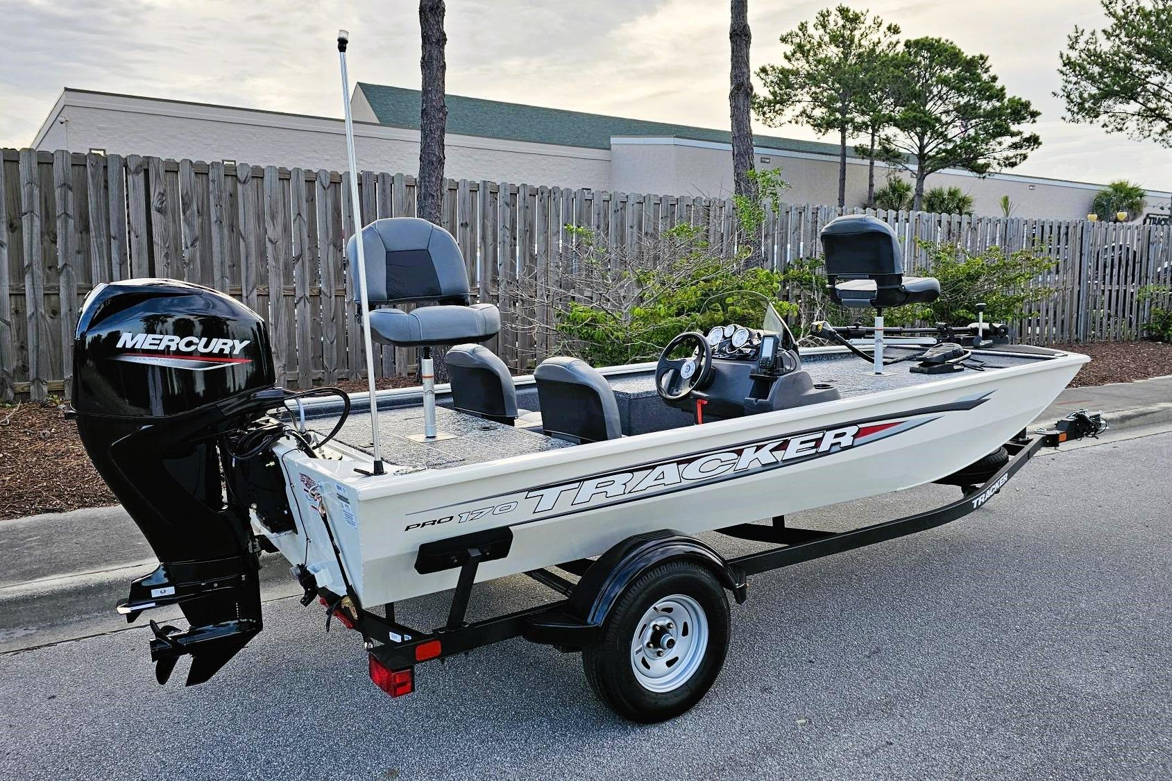 Tracker Pro 170 2026 Tracker Pro 170 boat with Mercury engine on trailer, parked outdoors.