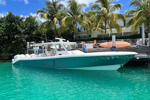 Everglades 435 Center Console 2016 Everglades 435 Center Console boat docked by palm trees in turquoise water.